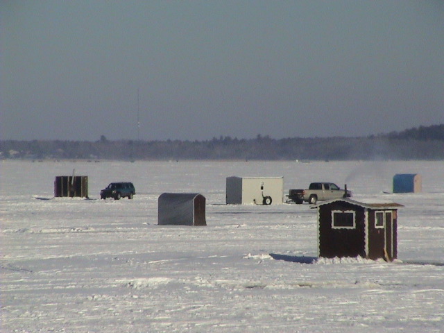 Guys sit in these boxes in sub-zero temperatures to catch fish. And drink beer.
