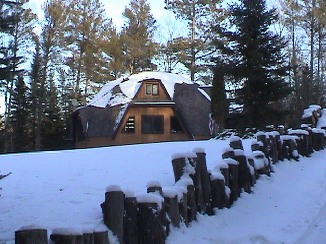 Snowcapped logs line the driveway.