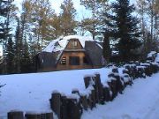 Snowcapped logs line the driveway.